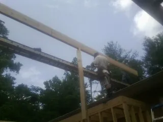 Carpenter setting a ridge beam over a new addition frame — Ice Dam Removal by Roofing Brothers in Silver Plume